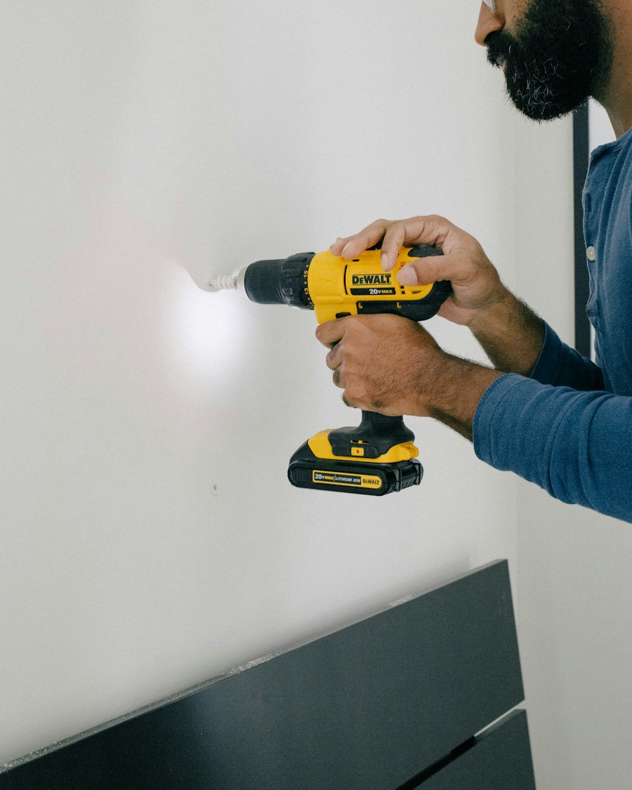 A technician drilling a wall